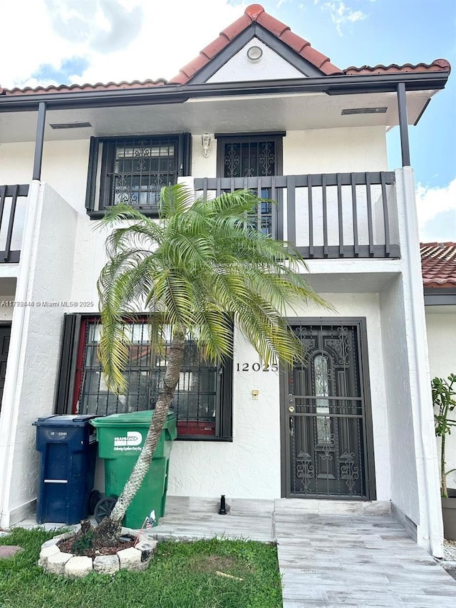 12025 SW 10th St Unit 204, Miami, FL 33184 - entrance to property with a balcony, a tiled roof, and stucco siding