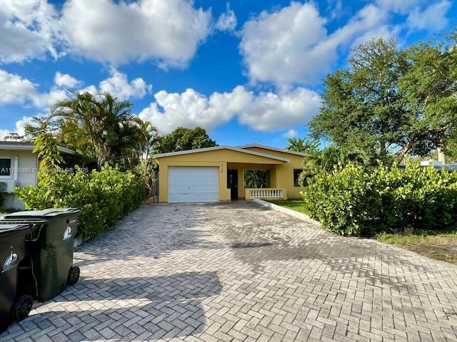 garage with decorative driveway