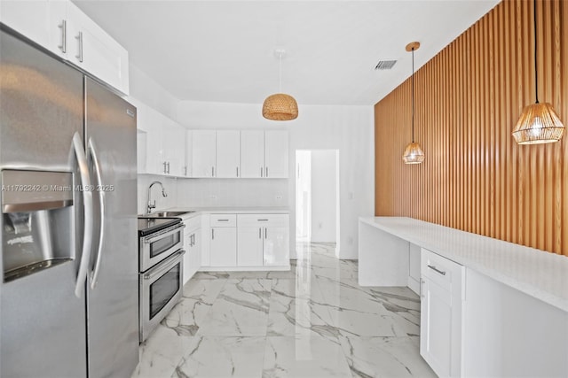 1683 NE 168th St, North Miami Beach, FL 33162 - kitchen with a sink, stainless steel appliances, marble finish floor, visible vents, and light countertops
