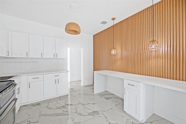 1683 NE 168th St, North Miami Beach, FL 33162 - kitchen with double oven range, light countertops, marble finish floor, white cabinetry, and visible vents