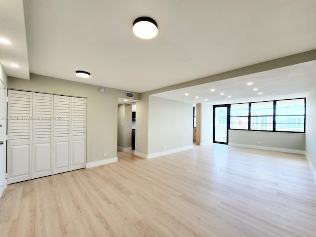 unfurnished living room featuring baseboards, recessed lighting, visible vents, and light wood finished floors