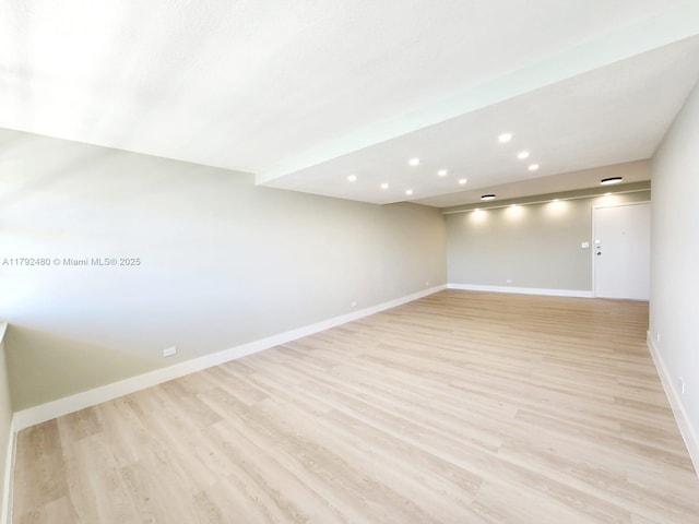 spare room with light wood-style floors, recessed lighting, and baseboards