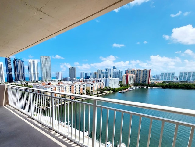 balcony featuring a city view and a water view