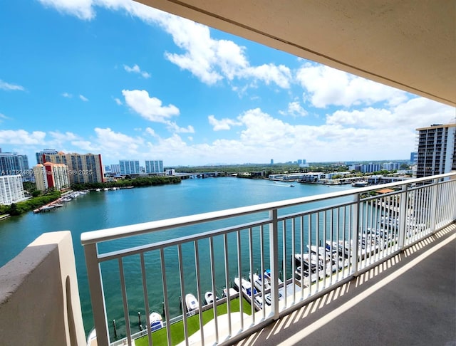 balcony featuring a water view and a city view
