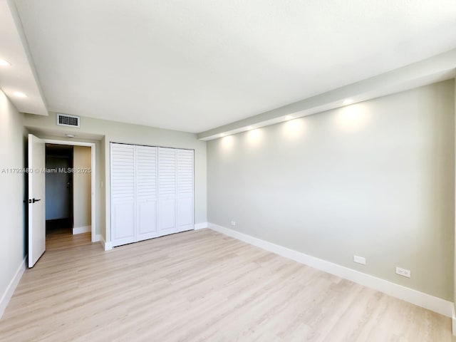 unfurnished bedroom with light wood finished floors, recessed lighting, visible vents, and baseboards