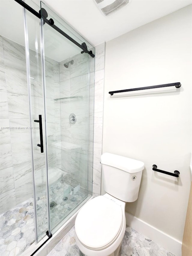 bathroom with toilet and a shower stall