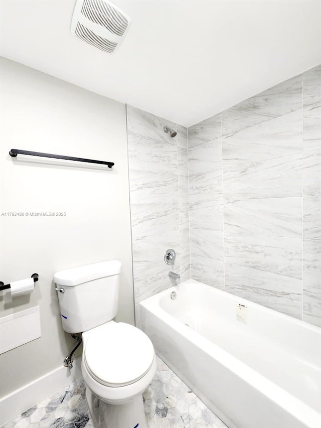 full bath featuring toilet, marble finish floor, visible vents, bathtub / shower combination, and baseboards