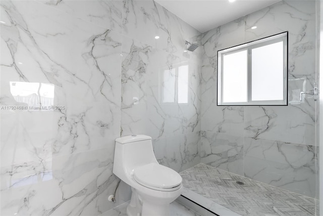 full bathroom with a marble finish shower and toilet