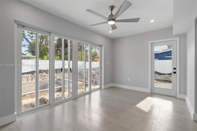 tiled spare room with recessed lighting, ceiling fan, and baseboards