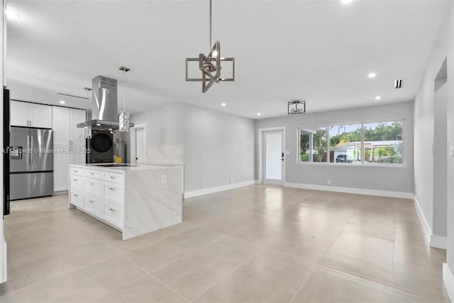kitchen featuring recessed lighting, stainless steel refrigerator, island exhaust hood, and white cabinetry