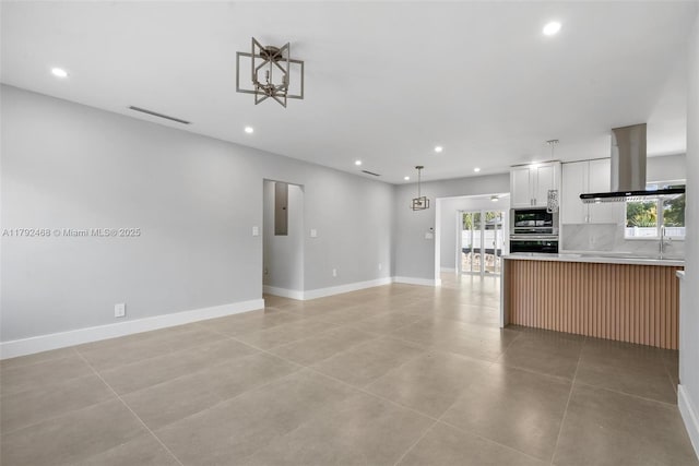 unfurnished living room with visible vents, recessed lighting, baseboards, and a wealth of natural light