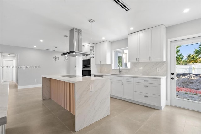 kitchen featuring a sink, white cabinets, backsplash, and island range hood