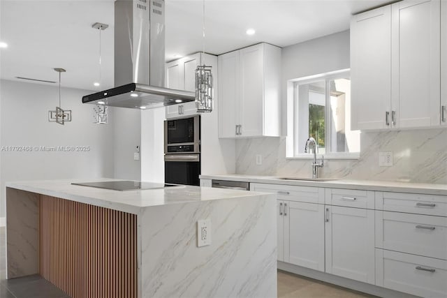 kitchen with decorative backsplash, white cabinets, island exhaust hood, a sink, and black appliances