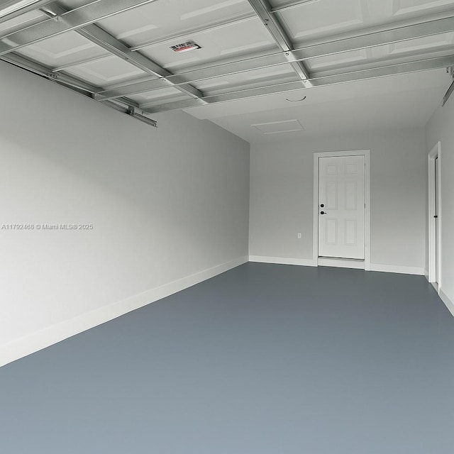 garage with baseboards and visible vents