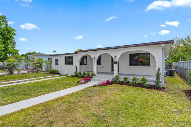 view of front of property featuring covered porch, a front yard, fence, cooling unit, and stucco siding