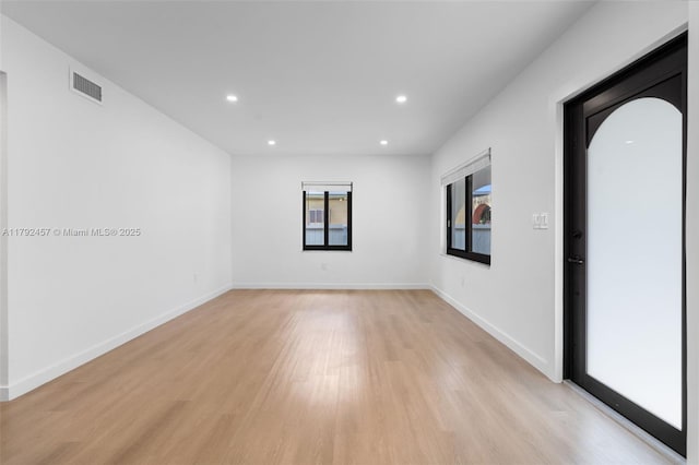 spare room with recessed lighting, baseboards, visible vents, and light wood-style flooring