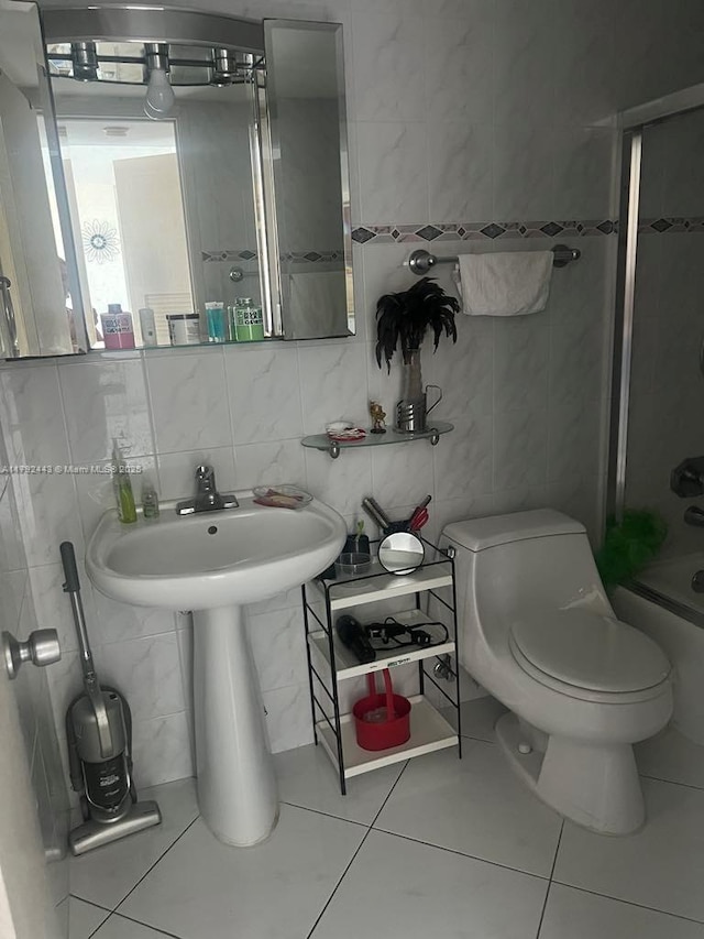 2841 NE 163rd St Unit 407, North Miami Beach, FL 33160 - full bathroom with tile walls, toilet, and tile patterned flooring