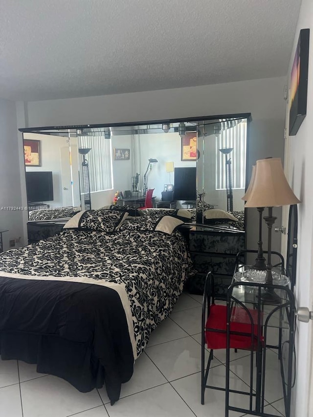 2841 NE 163rd St Unit 407, North Miami Beach, FL 33160 - bedroom featuring tile patterned floors and a textured ceiling