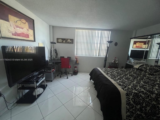 2841 NE 163rd St Unit 407, North Miami Beach, FL 33160 - bedroom with tile patterned flooring and a textured ceiling