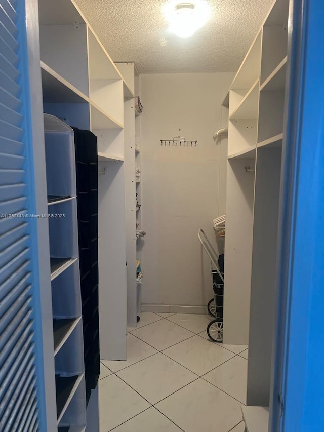 2841 NE 163rd St Unit 407, North Miami Beach, FL 33160 - spacious closet featuring light tile patterned floors