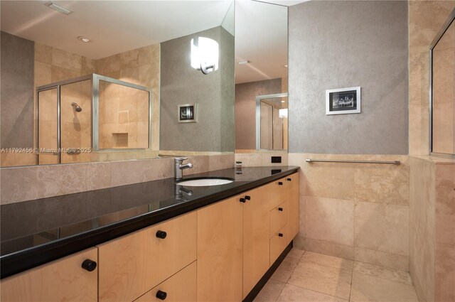 3425 Saddlebrook Ln, Weston, FL 33331 - bathroom featuring tile walls, a shower stall, tile patterned flooring, and vanity