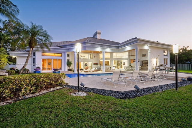 3425 Saddlebrook Ln, Weston, FL 33331 - back of house featuring a fenced in pool, a patio area, a chimney, and a standing seam roof