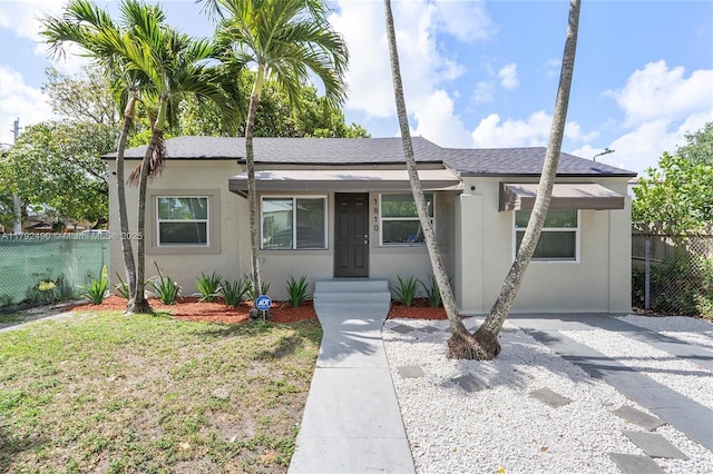 1810 NW 47th St, Miami, FL 33142 - single story home featuring a front lawn, fence, and stucco siding