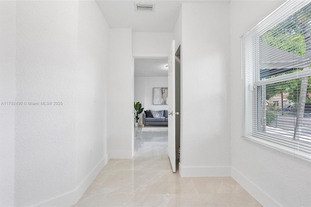 1810 NW 47th St, Miami, FL 33142 - hall featuring marble finish floor, visible vents, and baseboards