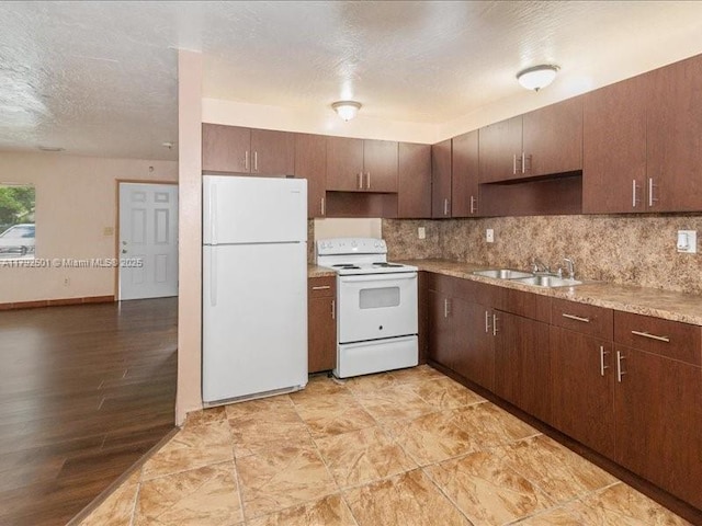 19357 NW 29th Ave, Miami Gardens, FL 33056 - kitchen featuring white appliances, a sink, a textured ceiling, backsplash, and light countertops