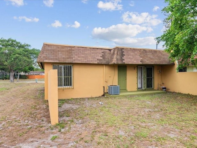 19357 NW 29th Ave, Miami Gardens, FL 33056 - back of house with stucco siding, mansard roof, and a shingled roof