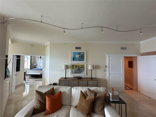 living area with baseboards, visible vents, and ornamental molding