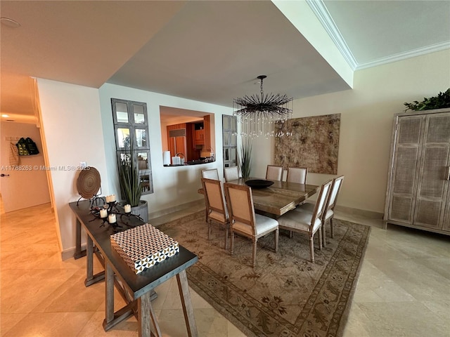 dining room featuring crown molding, an inviting chandelier, and baseboards