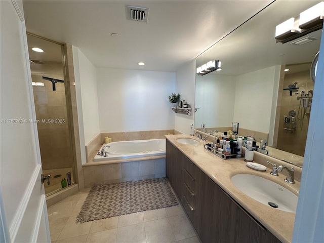 bathroom with a shower stall, a bath, tile patterned flooring, and a sink