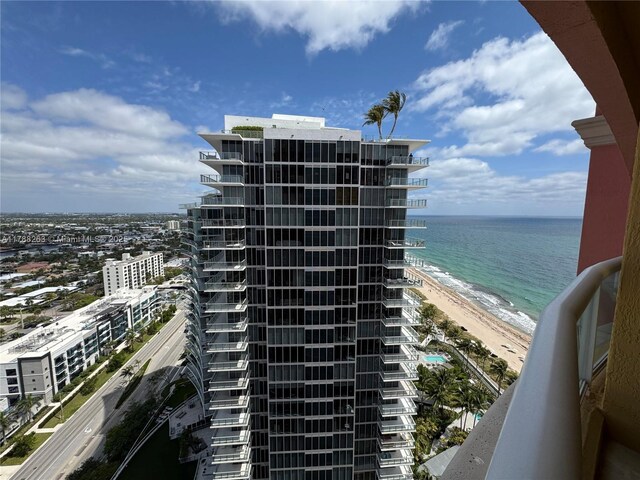 view of property with a view of the beach and a water view