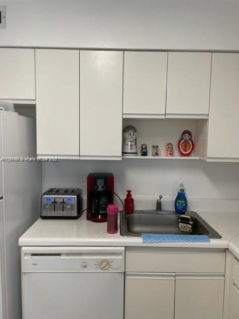 5161 Collins Ave Unit 506, Miami Beach, FL 33140 - kitchen with a sink, dishwasher, white cabinetry, and light countertops