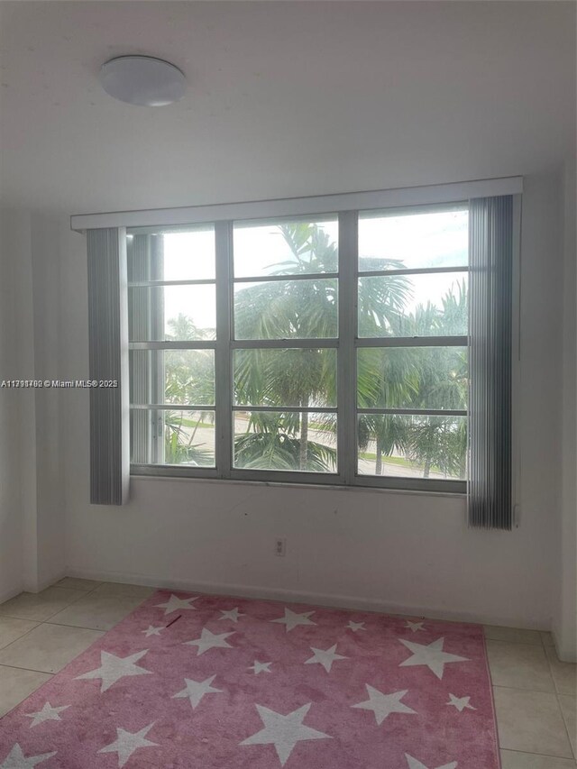 5161 Collins Ave Unit 506, Miami Beach, FL 33140 - tiled empty room featuring a wealth of natural light