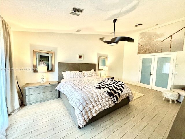 3699 Lakeview Blvd, Delray Beach, FL 33445 - bedroom with a textured ceiling, visible vents, french doors, and wood finished floors