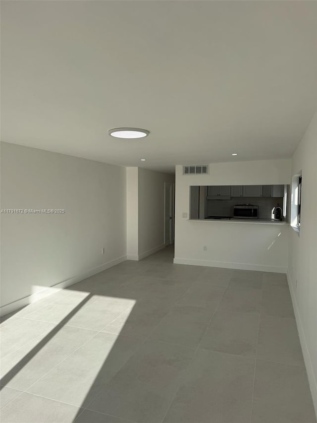 2939 Indian Creek Dr Unit 307, Miami Beach, FL 33140 - unfurnished living room with baseboards, tile patterned flooring, and visible vents
