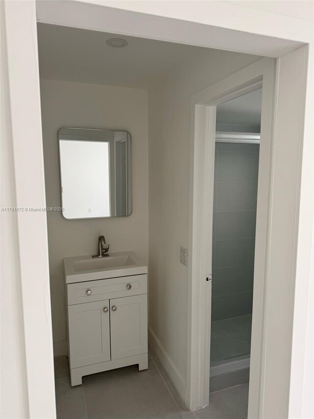 2939 Indian Creek Dr Unit 307, Miami Beach, FL 33140 - bathroom with vanity, tile patterned floors, baseboards, and a stall shower