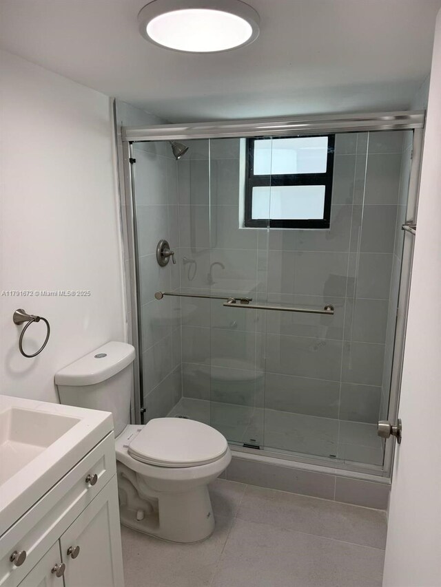 2939 Indian Creek Dr Unit 307, Miami Beach, FL 33140 - full bathroom with tile patterned flooring, a stall shower, toilet, and vanity