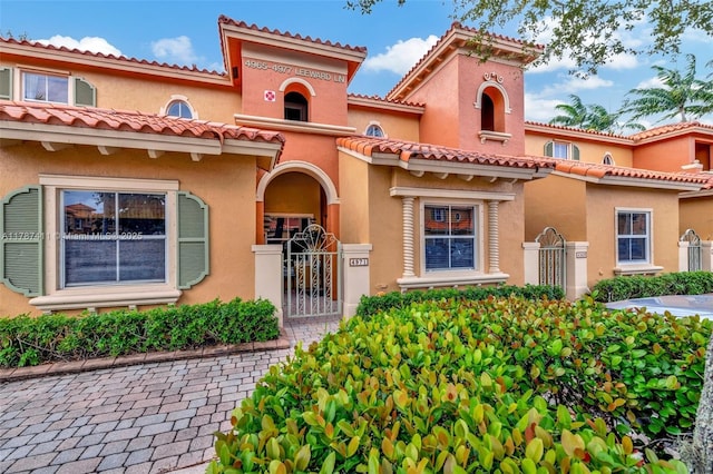 4971 Leeward Ln Unit 3004, Dania Beach, FL 33312 - mediterranean / spanish-style house featuring fence, a gate, and stucco siding