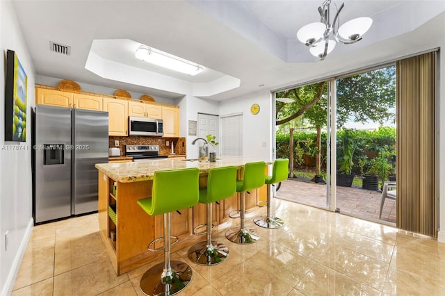 4971 Leeward Ln Unit 3004, Dania Beach, FL 33312 - kitchen with stainless steel appliances, a tray ceiling, visible vents, and tasteful backsplash
