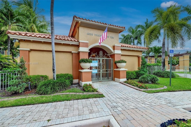 4971 Leeward Ln Unit 3004, Dania Beach, FL 33312 - view of front of property with a tiled roof, stucco siding, and a gate