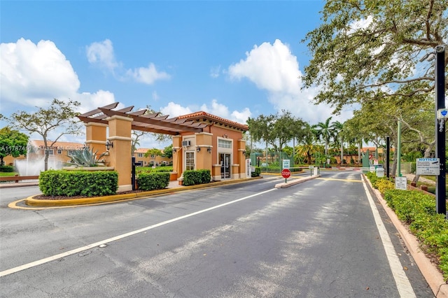 4971 Leeward Ln Unit 3004, Dania Beach, FL 33312 - view of street with street lights, traffic signs, a gated entry, and curbs