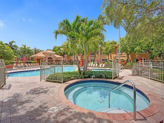 4971 Leeward Ln Unit 3004, Dania Beach, FL 33312 - community pool featuring a hot tub and a patio