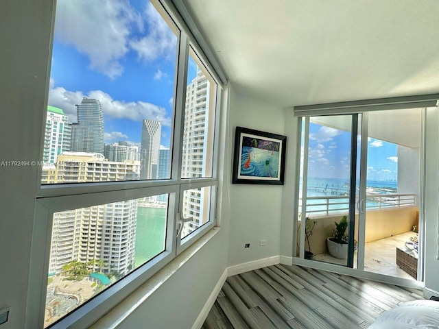808 Brickell Key Dr Unit 3007, Miami, FL 33131 - unfurnished room featuring plenty of natural light, wood finished floors, baseboards, a water view, and a wall of windows