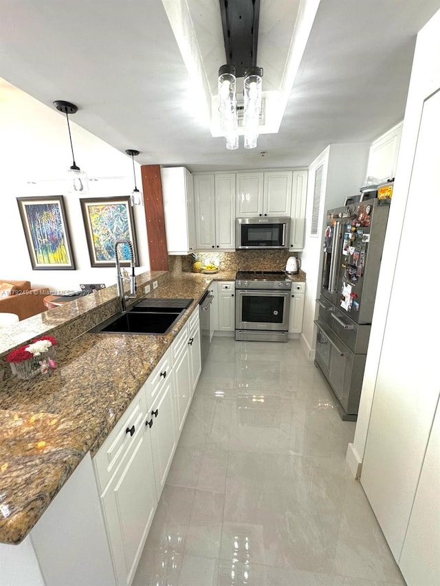 808 Brickell Key Dr Unit 3007, Miami, FL 33131 - kitchen featuring stainless steel appliances, a sink, white cabinets, and dark stone counters