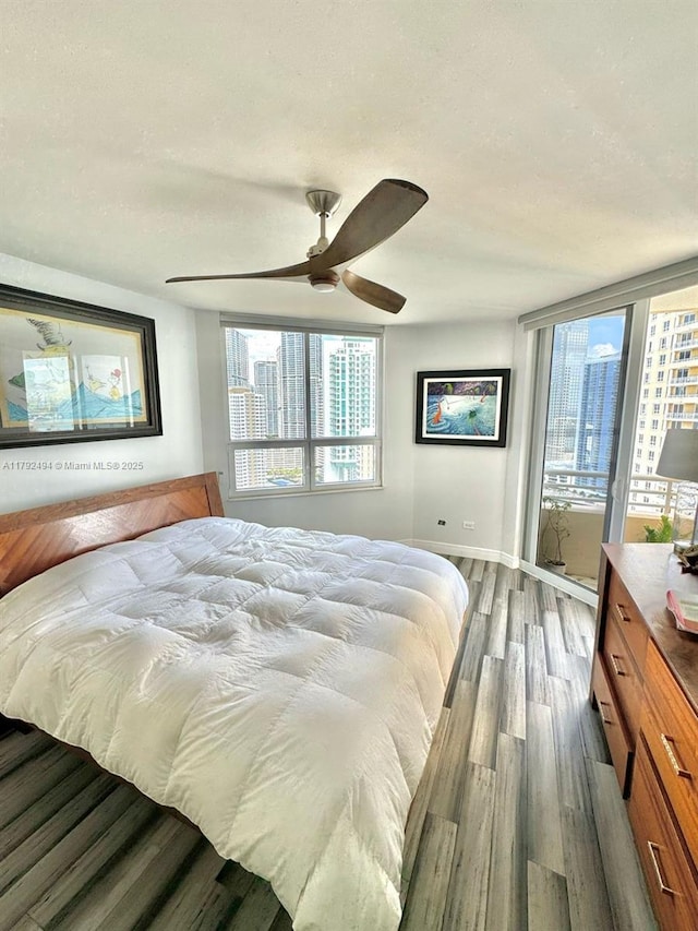 808 Brickell Key Dr Unit 3007, Miami, FL 33131 - bedroom with wood finished floors, a textured ceiling, access to exterior, ceiling fan, and baseboards