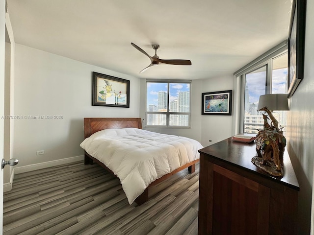 808 Brickell Key Dr Unit 3007, Miami, FL 33131 - bedroom featuring multiple windows, dark wood finished floors, and baseboards