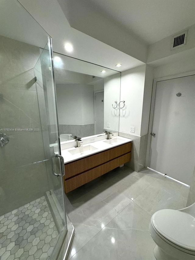 808 Brickell Key Dr Unit 3007, Miami, FL 33131 - bathroom with a stall shower, double vanity, recessed lighting, and toilet